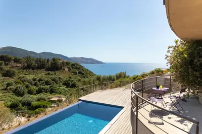 a villa with a swimming pool and a view of the ocean at AZUR E CASTELLU - CORSE SUD - Pied à terre IDEAL in Calcatoggio