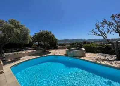 a large blue swimming pool in a yard at Résidence U Sognu in Porto-Vecchio
