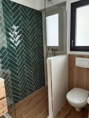 a bathroom with a toilet and a glass shower at Studio neuf porticcio in Porticcio
