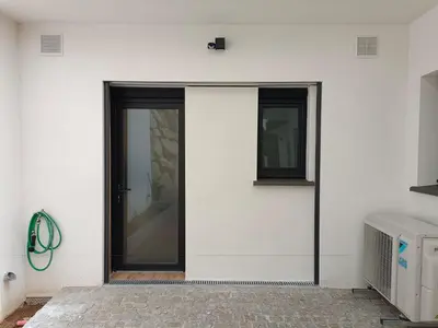 a white wall with a door and a window at Studio neuf porticcio in Porticcio