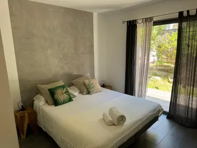 a bedroom with a large bed with towels on it at Villa en pierre avec piscine chauffée, à proximité des plus belles plages du sud de la Corse ! in Figari