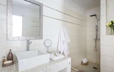 a white bathroom with a sink and a mirror at Villa en pierre avec piscine chauffée, à proximité des plus belles plages du sud de la Corse ! in Figari
