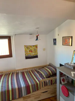 a bedroom with a bed and a window at T4 Terrasses Vieille ville, Ajaccio in Ajaccio