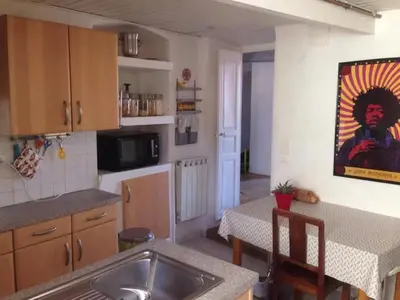 a kitchen with a sink and a table at T4 Terrasses Vieille ville, Ajaccio in Ajaccio