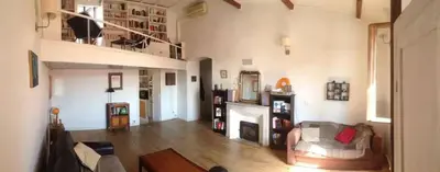 a living room with a couch and a fireplace at T4 Terrasses Vieille ville, Ajaccio in Ajaccio