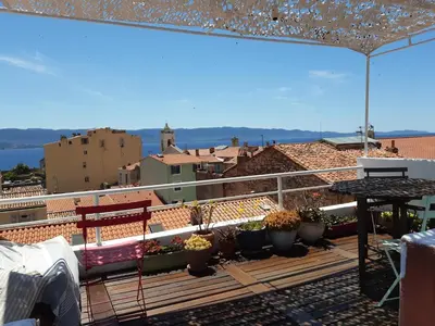a balcony with a table and potted plants on it at T4 Terrasses Vieille ville, Ajaccio in Ajaccio