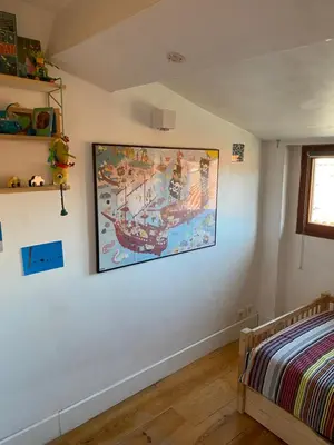 a bedroom with a large painting on the wall at T4 Terrasses Vieille ville, Ajaccio in Ajaccio