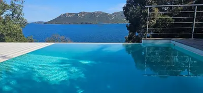 a swimming pool with a view of the water at Marina-piscine privée-wifi-Accès Sporting Club Marina di Fiori in Porto-Vecchio