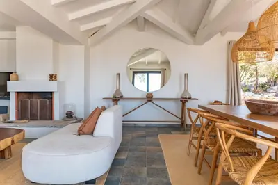 a living room with a white couch and a table at Casa Rocca Di Pianotolli in Pianottoli-Caldarello
