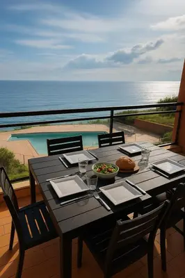 a table with a bowl of food on a balcony at Studio les pieds dans l'eau in Santa-Lucia-di-Moriani