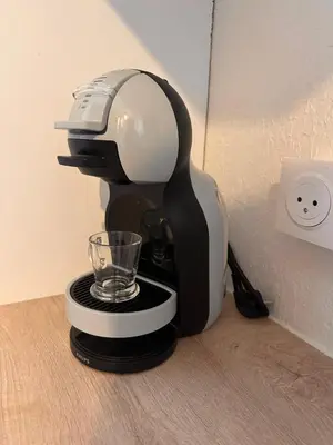 a black and white coffee maker with a glass at Studio les pieds dans l'eau in Santa-Lucia-di-Moriani