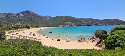 a beach with a bunch of people in the water at Casa Mimosa in Piana