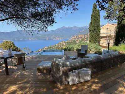 a patio with a couch and a table with a view at Casa Mimosa in Piana