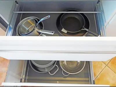two pots and pans inside of a kitchen drawer at So Leil So Fun à Porticcio - 45m2 - Grand lit 180 - Plage à pied - Wifi fibre - Terrasse in Porticcio
