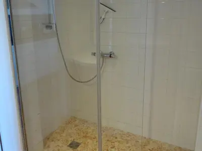 a shower with a glass door in a bathroom at So Leil So Fun à Porticcio - 45m2 - Grand lit 180 - Plage à pied - Wifi fibre - Terrasse in Porticcio