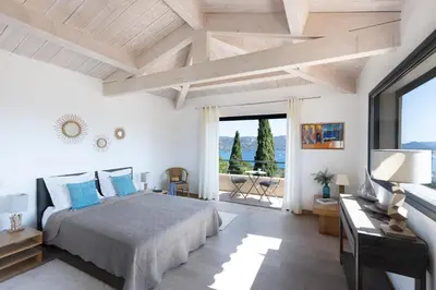 a bedroom with a large bed and a television at Villa MARINARCA sitew Porto Vecchio Marina di Fiori Vue mer piscine chauffée Clim plage à pied tennis in Porto-Vecchio
