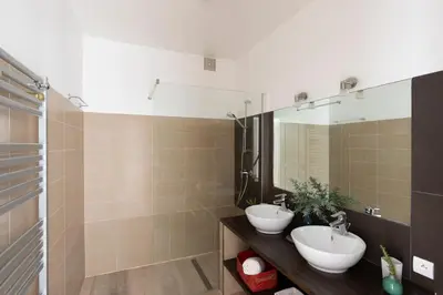a bathroom with two sinks and a mirror at Villa MARINARCA sitew Porto Vecchio Marina di Fiori Vue mer piscine chauffée Clim plage à pied tennis in Porto-Vecchio