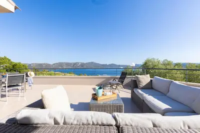 a patio with couches and a view of the water at Villa MARINARCA sitew Porto Vecchio Marina di Fiori Vue mer piscine chauffée Clim plage à pied tennis in Porto-Vecchio