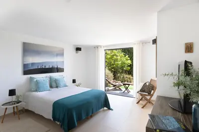 a white bedroom with a bed and a large window at Villa MARINARCA sitew Porto Vecchio Marina di Fiori Vue mer piscine chauffée Clim plage à pied tennis in Porto-Vecchio