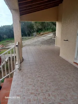 a porch of a house with a balcony at Residence les Lavandes in Olmeto