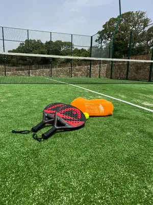 two frisbees are laying on a tennis court at Domaine Pozzo di Mastri hôtel & spa in Figari