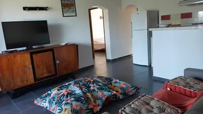 a living room with a flat screen tv and a couch at Casapiana 7 in San-Gavino-di-Carbini
