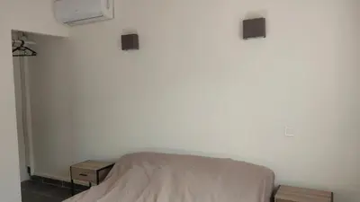 a bedroom with a bed and two night stands at Casapiana 7 in San-Gavino-di-Carbini
