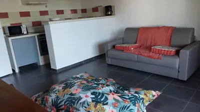 a living room with a couch and a table at Casapiana 7 in San-Gavino-di-Carbini