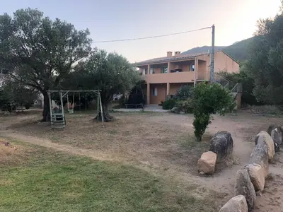 a house with a playground in front of a yard at Casapiana 7 in San-Gavino-di-Carbini
