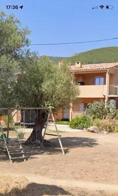 a swing set in front of a house at Casapiana 7 in San-Gavino-di-Carbini