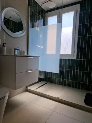 a bathroom with a sink and a mirror and a toilet at Charmant Appartement Centre-Ville d'Ajaccio in Ajaccio