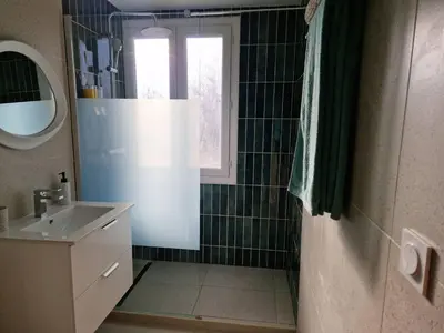 a bathroom with a sink and a shower with a window at Charmant Appartement Centre-Ville d'Ajaccio in Ajaccio