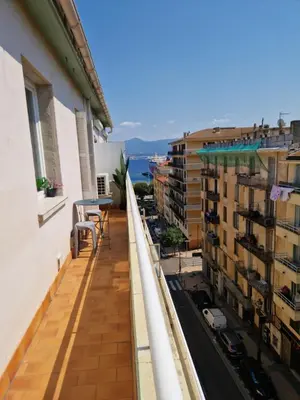 a balcony of a building with a view of the water at Charmant Appartement Centre-Ville d'Ajaccio in Ajaccio