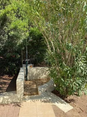 a concrete walkway next to a tree at Villa panoramic - Dream and Suite Lodge in Vico