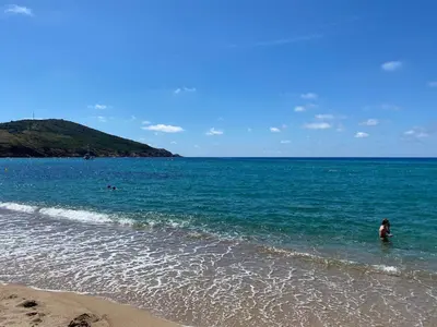 a person standing in the water at the beach at Sagone villa sea view in Vico