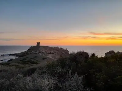 a lighthouse on top of a rock in the ocean at Sagone villa sea view in Vico