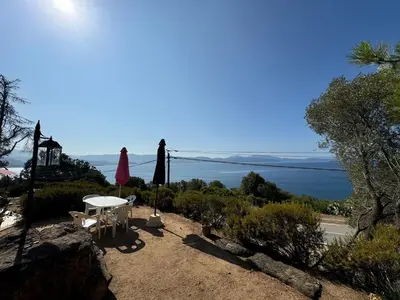 a patio with a table and a view of the water at Sagone villa sea view in Vico