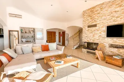 a living room with a couch and a fireplace at Villa Golfo Di Sogno in Porto-Vecchio