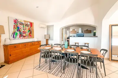 a dining room with a table and chairs at Villa Golfo Di Sogno in Porto-Vecchio