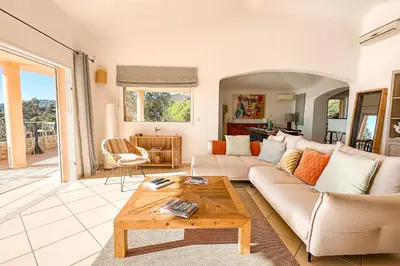 a living room with a couch and a coffee table at Villa Golfo Di Sogno in Porto-Vecchio