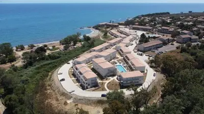 an aerial view of a resort next to the ocean at marina di bravone - corse - linguizzetta in Linguizzetta