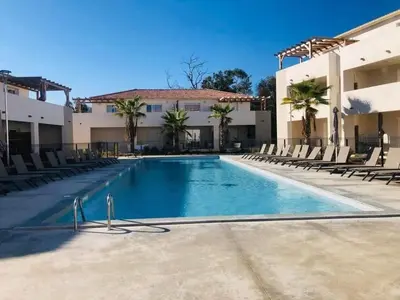a large swimming pool in front of a building at marina di bravone - corse - linguizzetta in Linguizzetta