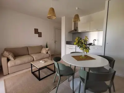 a living room with a table and a couch at marina di bravone - corse - linguizzetta in Linguizzetta