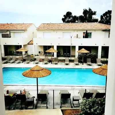 a large swimming pool with chairs and umbrellas at marina di bravone - corse - linguizzetta in Linguizzetta