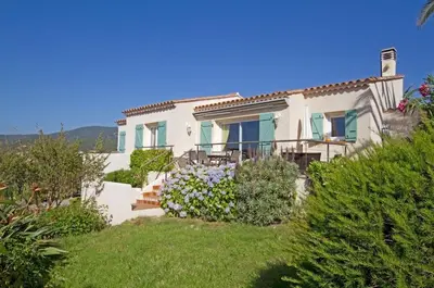 a villa with a view of the garden at Villa Abbracciu climatisée avec piscine chauffée et vue mer in Pietrosella