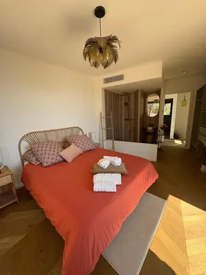 a bedroom with a large orange bed with towels on it at Casa Raphael in Ajaccio