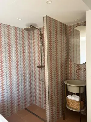 a bathroom with a shower and a table at Casa Raphael in Ajaccio