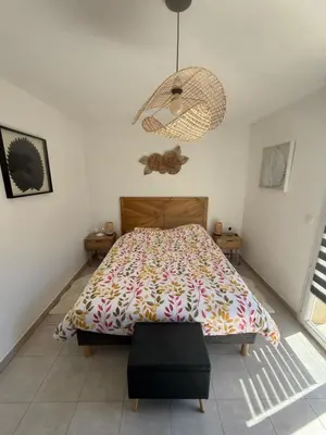 a bedroom with a bed with a colorful comforter at Villa désirée à Santa Maria Poggio in Santa-Maria-Poggio