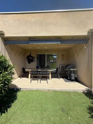 a patio with a table and chairs on it at Villa désirée à Santa Maria Poggio in Santa-Maria-Poggio