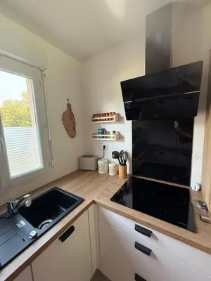 a kitchen with a sink and a black microwave at Villa désirée à Santa Maria Poggio in Santa-Maria-Poggio